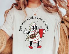 "Indulge in the holiday spirit with our whimsical collection boasting the \"Out Here Looking Like A Snack Funny Christmas Shirt,\" \"Humorous Christmas Cake Sweatshirt,\" \"Humor Saying Christmas Shirt,\" and \"Like A Snack Shirt.\" Designed to add a sprinkle of laughter to your festive wardrobe, these pieces are perfect for those who love to embrace the holiday season with a touch of humor. Whether you're eyeing a playful twist on traditional sayings or want to flaunt your festive vibes with a Snack Humor, Looking Like A Snack, Sassy Shirts, Tree Cake, Christmas Tree Cake, Christmas Tree Shirt, Tree Shirt, Funny Christmas Shirts, Comfort And Joy