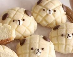 some cookies are shaped like teddy bears and have chocolate chips on them to make them look like they're ready to eat