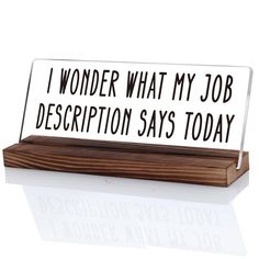 a desk sign that says i wonder what my job description says today on the front