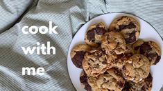 a white plate topped with chocolate chip cookies next to a text that reads cook with me