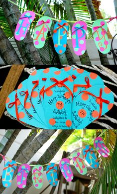 colorful paper fans are hanging from a tree with happy birthday signs on them and palm trees in the background