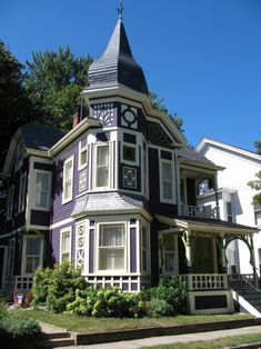 a purple and white victorian style house with a steeple