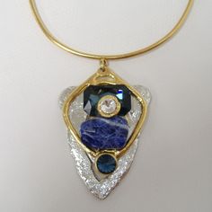 Large Chunky Blue & Crystal Pendant Necklace By J. Jansen. Unique Necklace In Clear Crystal & Shades Of Blue Colored Semi-Precious Stones. Plated In 24 Kt Gold & A Non-Tarnish Silver Finish. Adjustable Length From Approx. 14" To 16". New With Tag. 100 407 263 Modern Blue Pendant Jewelry, Elegant Blue Crystal Necklace With Gemstone Accents, Luxury Blue Jeweled Necklaces, Modern Blue Gemstone Necklace, Blue Pendant Necklace With Stones, Blue Gemstone Necklace For Party, Modern Blue Necklaces For Parties, Blue Costume Jewelry With Stones, Modern Blue Necklace For Party