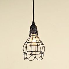 a light that is hanging from a wire on the ceiling with a bulb attached to it