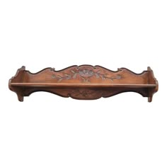 a wooden shelf with carvings on it