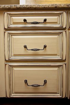 an old dresser with two drawers and knobs