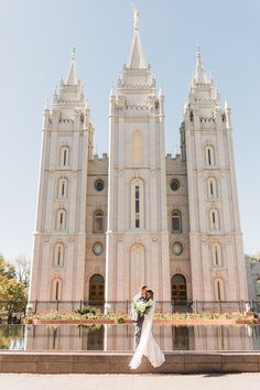 a bride and groom standing in front of the salt lake temple