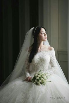 a woman in a wedding dress holding a bouquet