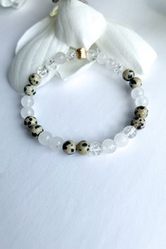 I AM PROTECTED beaded bracelet, Yoga bracelet, Mala Meditation bracelet, Gemstone bracelet Dainty Crystal Crackle & White Quartz Dalmatian gemstone mala beauty.  Liven up your day with this gorgeous Dalmatian Jasper Intention bracelet, accented with a stunning 18kt gold plated swirl bead.    Share a little love with your friends!  Namaste 🙏 Gorgeous! Yes please 🥰  Namaste 🙏 💫 Dalmatian Jasper The black spots within Dalmatian Jasper are Black Tourmaline, which gives this stone the energy of s White Bangle Bracelet With Natural Stones, White Spiritual Bracelets With Faceted Beads, White Beaded Rosary Bracelet For Healing, I Am Protected, White Quartz Crystal, Intention Bracelets, Mala Meditation, Meditation Bracelet, Dalmatian Jasper