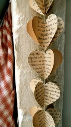 some paper hearts hanging from a wall