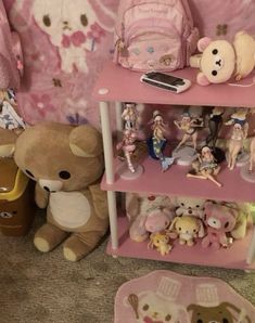 there are many stuffed animals and toys on the shelves in this room with pink walls