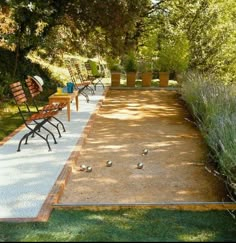 an empty park with benches and tables in the grass