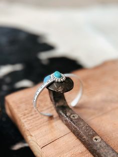 a ring sitting on top of a piece of wood