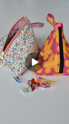 two small bags are sitting next to each other on the table and one is filled with candy