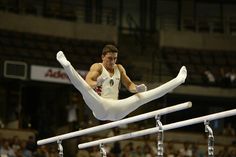 a man is doing tricks on the balance bars