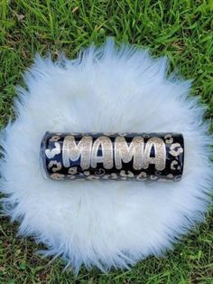 an animal fur rug with the word mama written on it in silver letters and black lettering