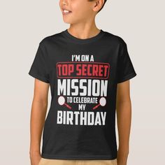 a young boy wearing a t - shirt that says i'm on top secret mission to celebrate my birthday