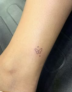 a small butterfly tattoo on the ankle