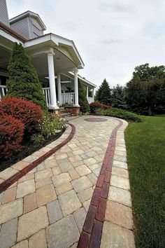 a brick walkway in front of a house