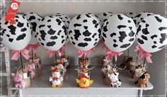 there are many balloons with animals on them in the shape of cow's heads