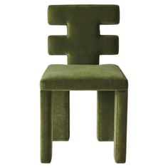 a green chair that is made out of wood and has the shape of a cross on it