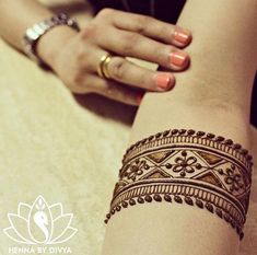 a woman's arm with henna tattoos on it