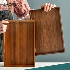 a woman is holding two pieces of wood