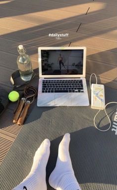 a laptop computer sitting on top of a table next to a pair of white socks