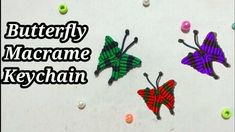 three colorful butterfly magnets sitting on top of a white surface next to balls and beads