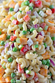 a pasta salad with peas, carrots and peas