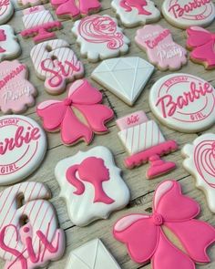 decorated cookies with pink and white icing on a table