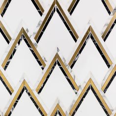 an abstract white and gold tile design with black lines in the center, on top of each other