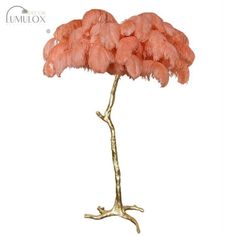 a pink flower on a gold branch with white background and the words unluox above it