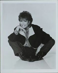 a black and white photo of a woman sitting on the ground