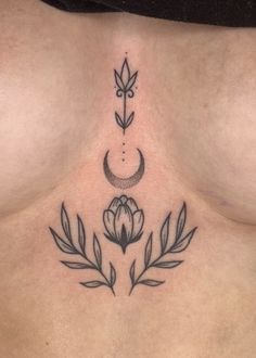 a woman's stomach with an arrow and flower tattoo on the side of her chest