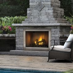 an outdoor fireplace next to a swimming pool