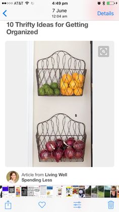 two metal baskets filled with fruit sitting on top of a wall