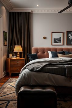 a bedroom with a large bed and pictures on the wall