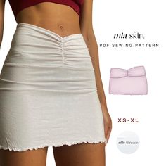 a woman wearing a white skirt and red top with her panties folded up next to her