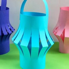 three different colored paper lanterns sitting next to each other