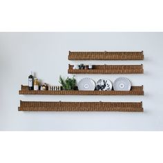 three wooden shelves with plates and bottles on them