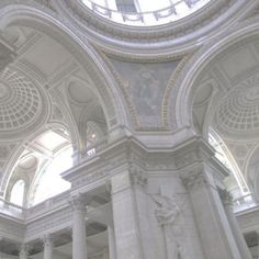 the inside of a building with columns and arches