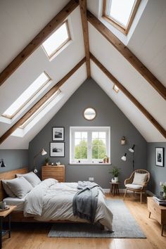 an attic bedroom with white and gray walls, wood flooring and vaulted ceiling beams