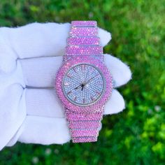 Step into elegance with this fully iced-out diamond timepiece that mirrors genuine luxury watches. We utilize premium simulated diamonds crafted from high-refractive crystals, ensuring a sparkle that rivals authentic diamonds under the light! INCLUDES AN EASY-TO-USE SIZE ADJUSTMENT TOOL Specifications: - Gender: Women's  - Case Size: 40mm - Movement: Quartz Movement - Battery: Included - Sizing: 6-inch band - Adjustable: Links are removable to fit your wrist - Back: Stainless Steel - Lock: Deployment Clasp - Stone: VVS Diamond Simulate - Case Material: Alloy - Finish: Silver Plating  Whether you're dressing up for casual days, or events, or gifting someone special on occasions like Graduations, Valentine's Day, Anniversaries, Birthdays, Thanksgiving, Christmas, New Year, or Mother's Day, t Diamond White Watches With Rhinestones For Gift, Crystal Bling Watches, Diamond Watch With Rhinestones And Round Dial, Round Crystal Watches With Rhinestones, Crystal Round Watches With Rhinestones, Crystal Watches With Rhinestones, Diamond White Iced Out Watches As Gift, Gift Iced Out Diamond White Watch, Pink Watch With Diamond Hour Markers