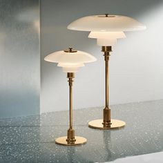 two lamps sitting on top of a table next to each other