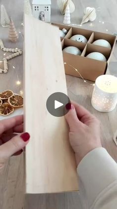 a woman is making christmas decorations with wood