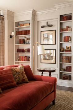 a living room filled with furniture and lots of books