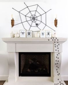 a white fireplace with spider web decorations on it