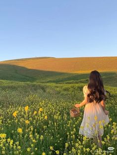 a girl in a field with yellow flowers