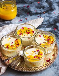 four small desserts on a plate with flowers